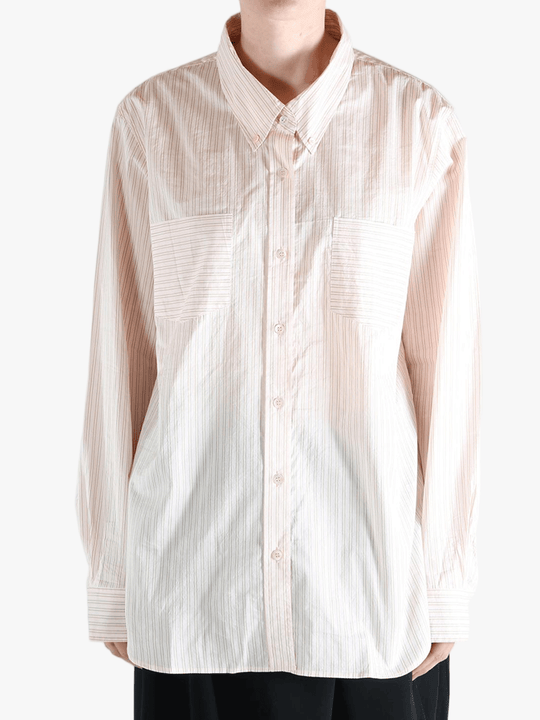 Tan shirts worn by a person, showing the shirt's fit