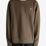 Brown knitwear worn by a person, showing the knitwear fit