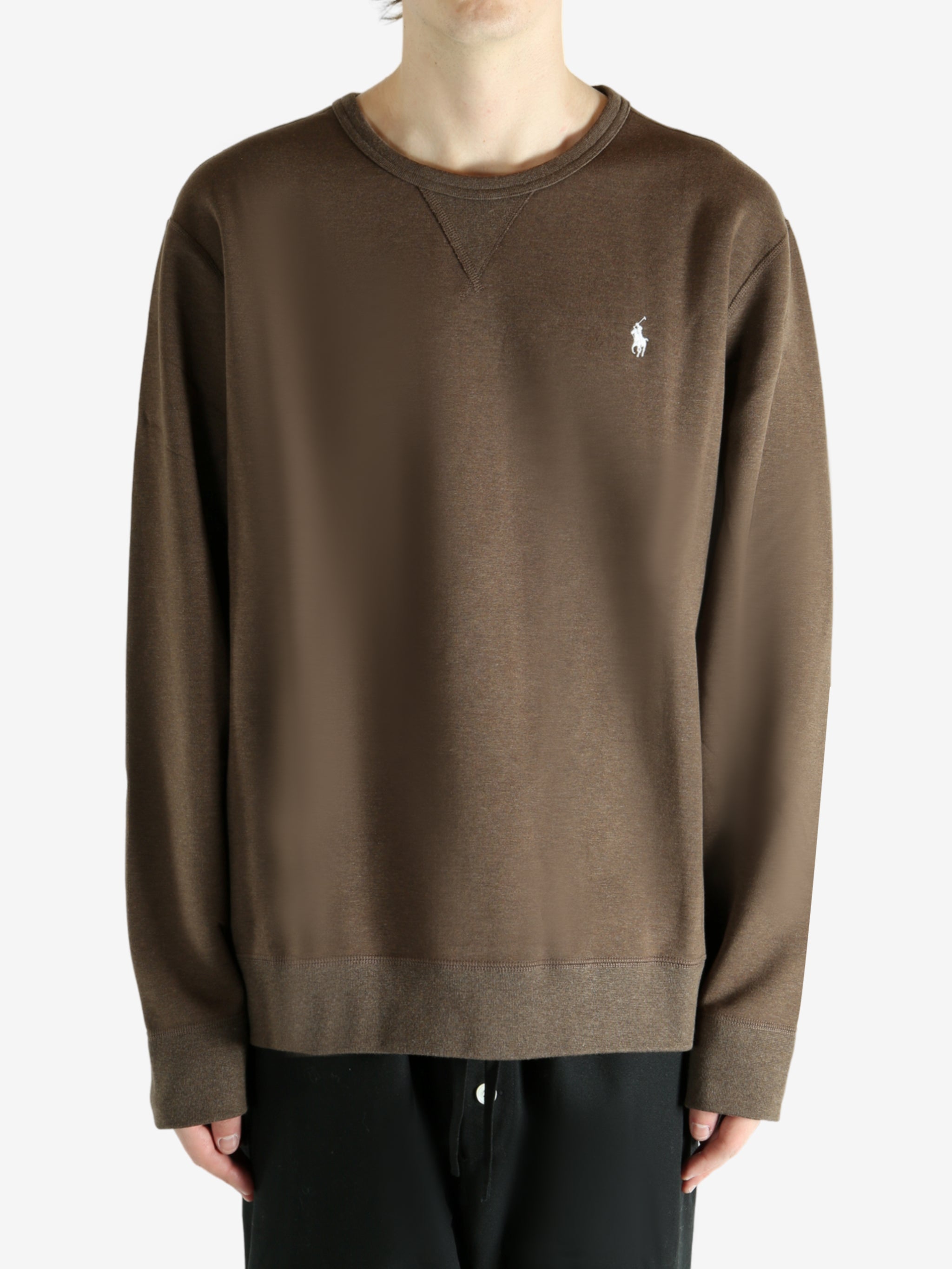 Brown knitwear worn by a person, showing the knitwear fit