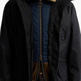 Black jacket worn by a person, showing the jacket fit