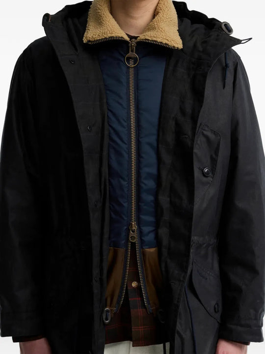 Black jacket worn by a person, showing the jacket fit