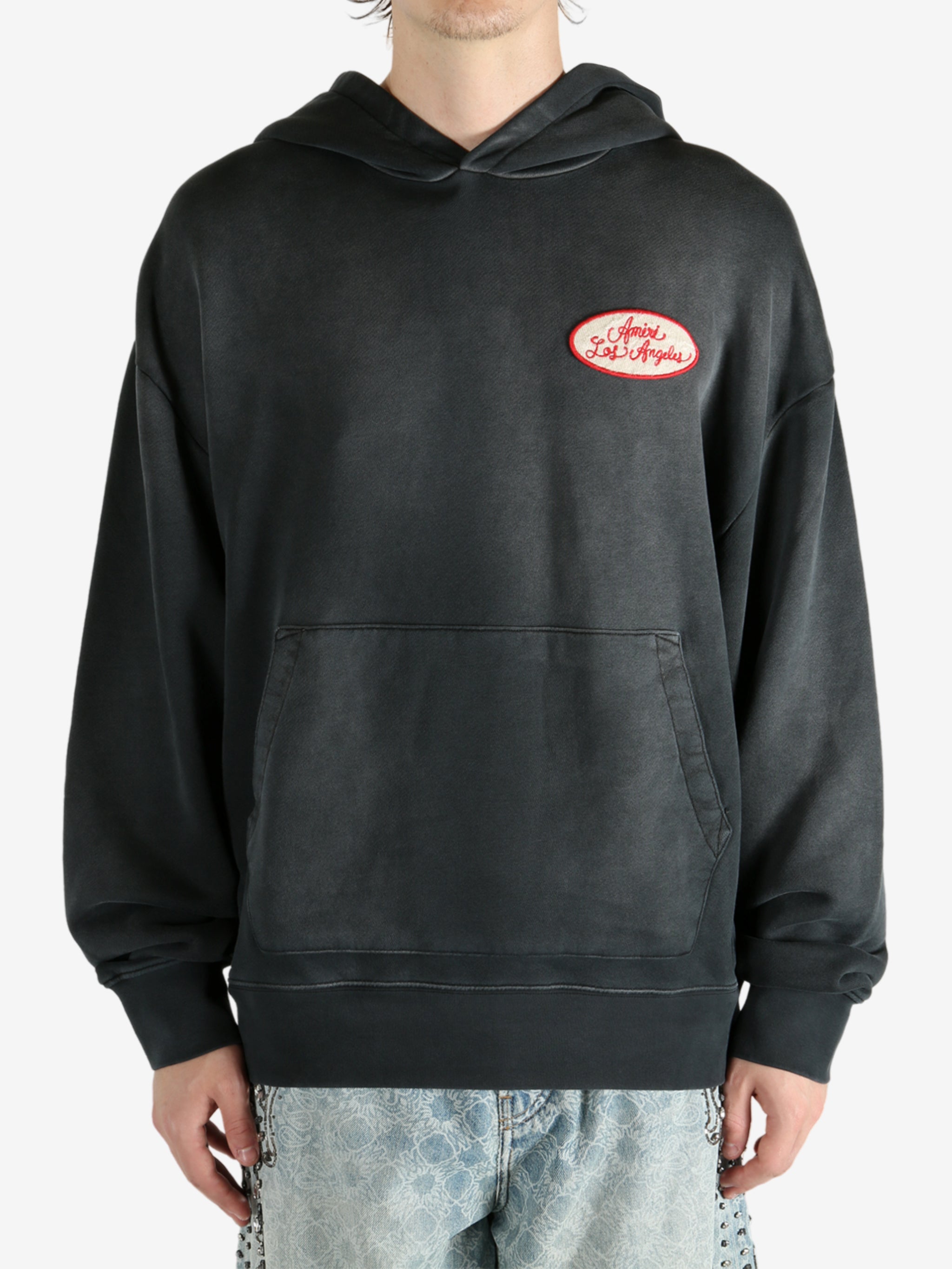 Black hoodie worn by a person, showing the hoodie’s fit