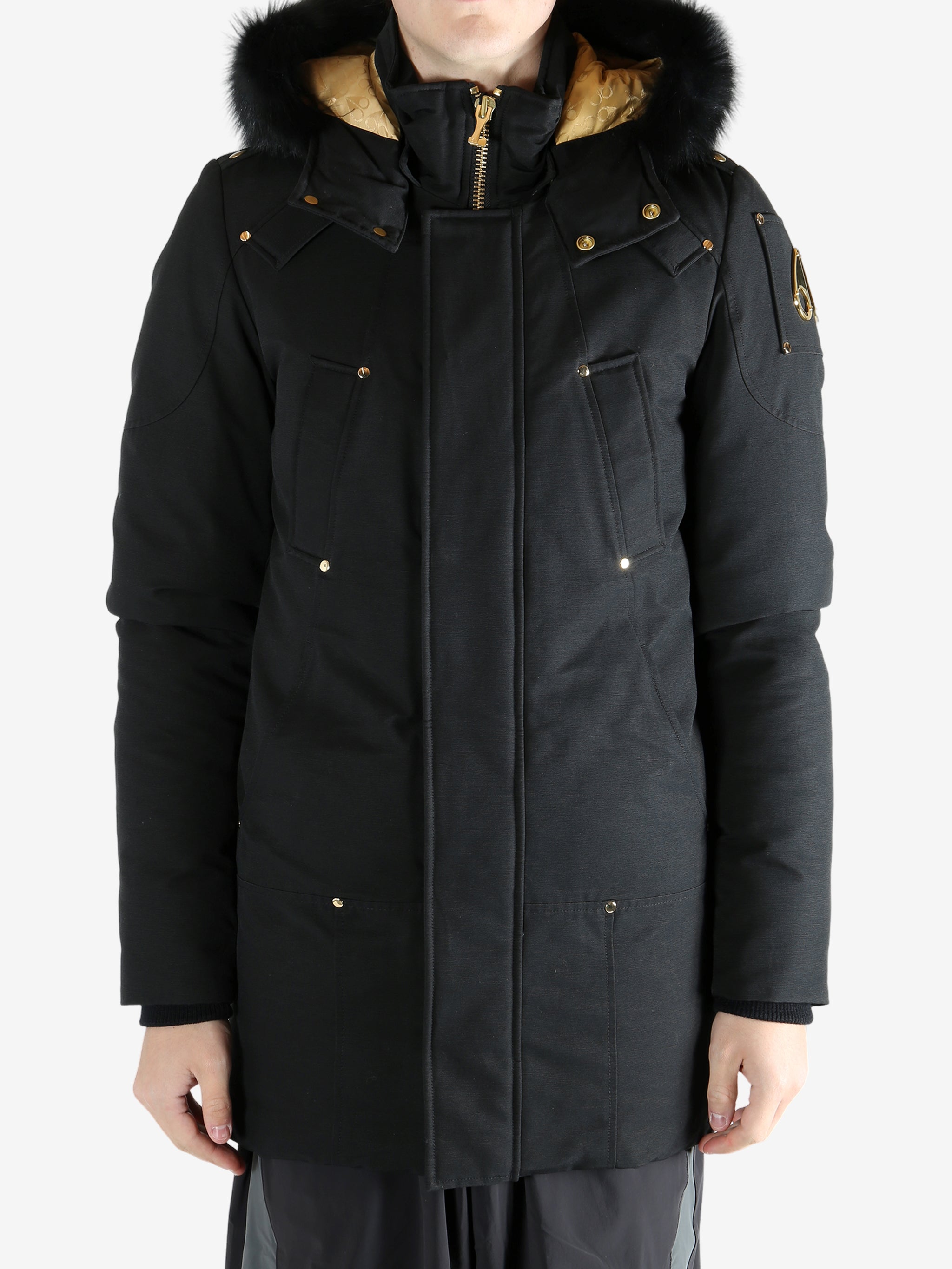 Black coat worn by a person, showing the coat's fit