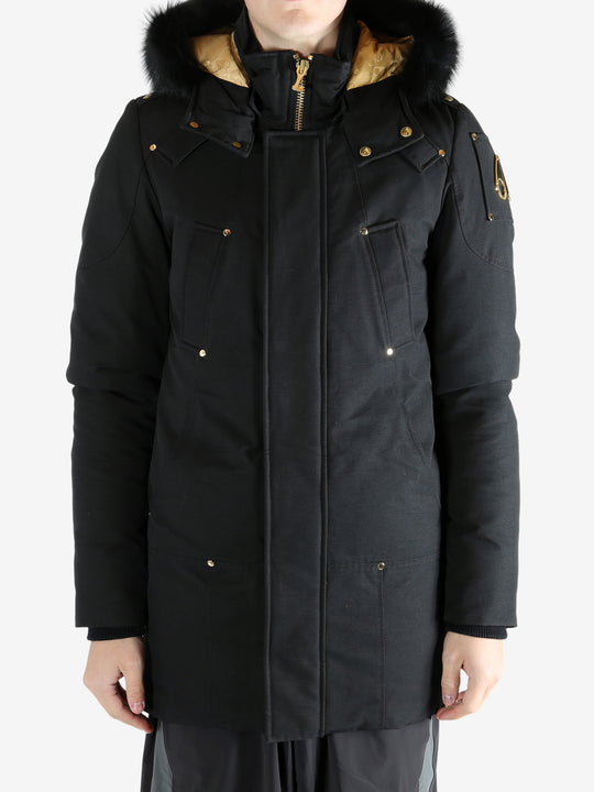 Black coat worn by a person, showing the coat's fit