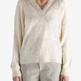 Tan knitwears worn by a person, showing the knitwears fit