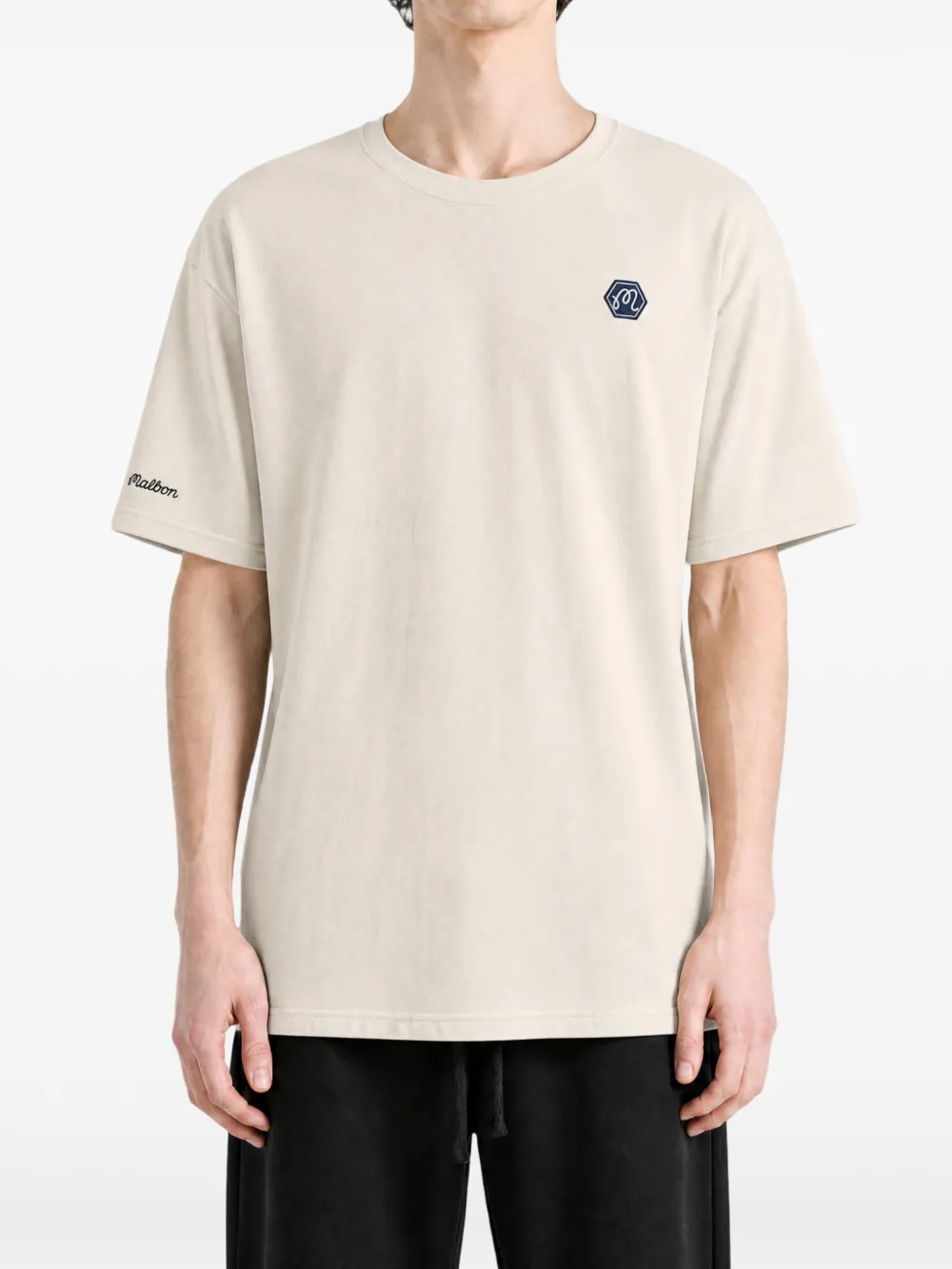Tan t-shirt worn by a person, showing the t-shirt fit