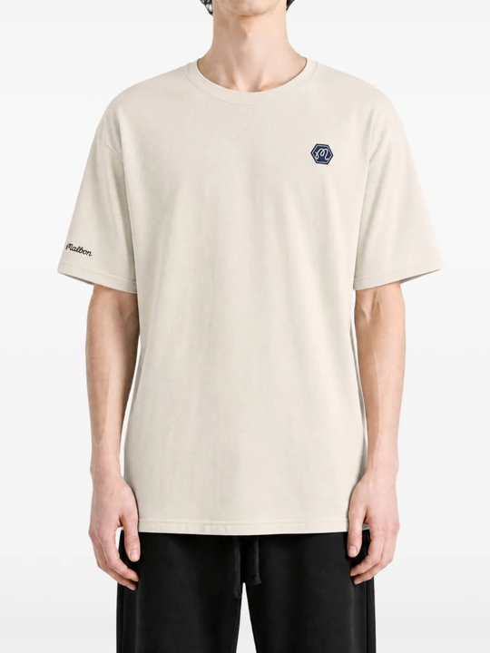 Tan t-shirt worn by a person, showing the t-shirt fit