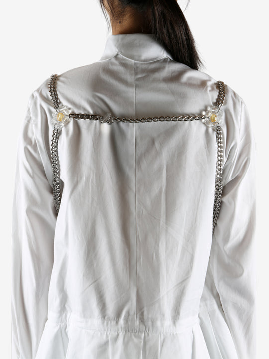 White top worn by a person, showing the top's fit