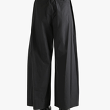 Black pants worn by a person, showing the pants fit