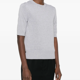 Grey t-shirt worn by a person, showing the cotton fit