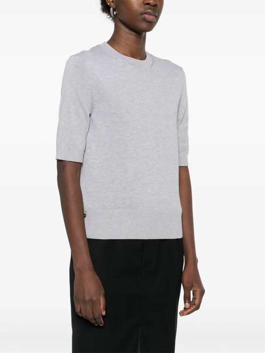 Grey t-shirt worn by a person, showing the cotton fit