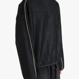 Black shirt worn by a person, showing the shirt's fit