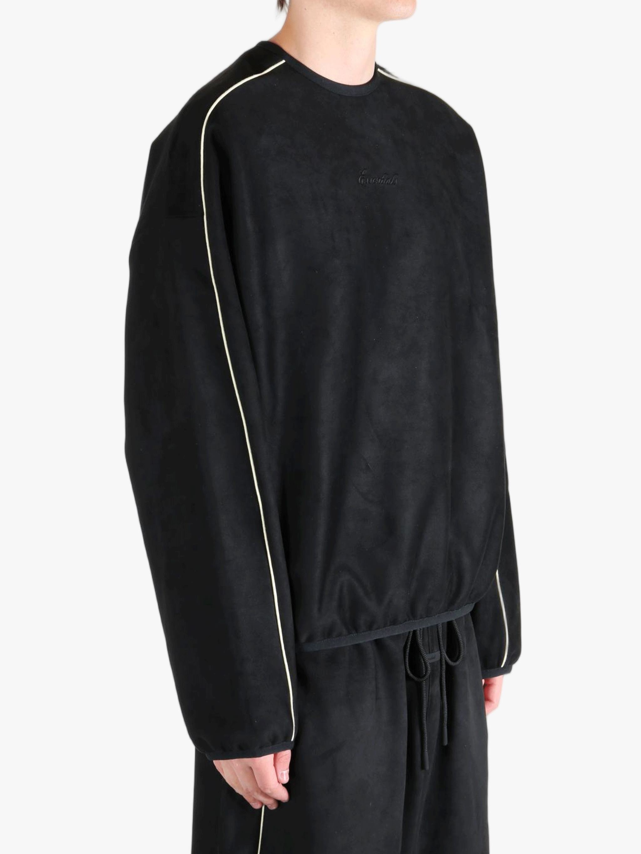 Black shirt worn by a person, showing the shirt's fit