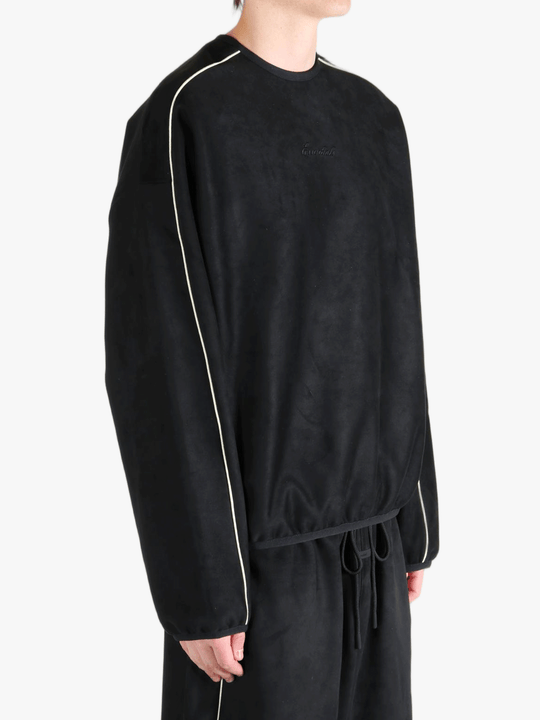 Black shirt worn by a person, showing the shirt's fit