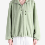 Green jacket worn by a person, showing the jacket fit