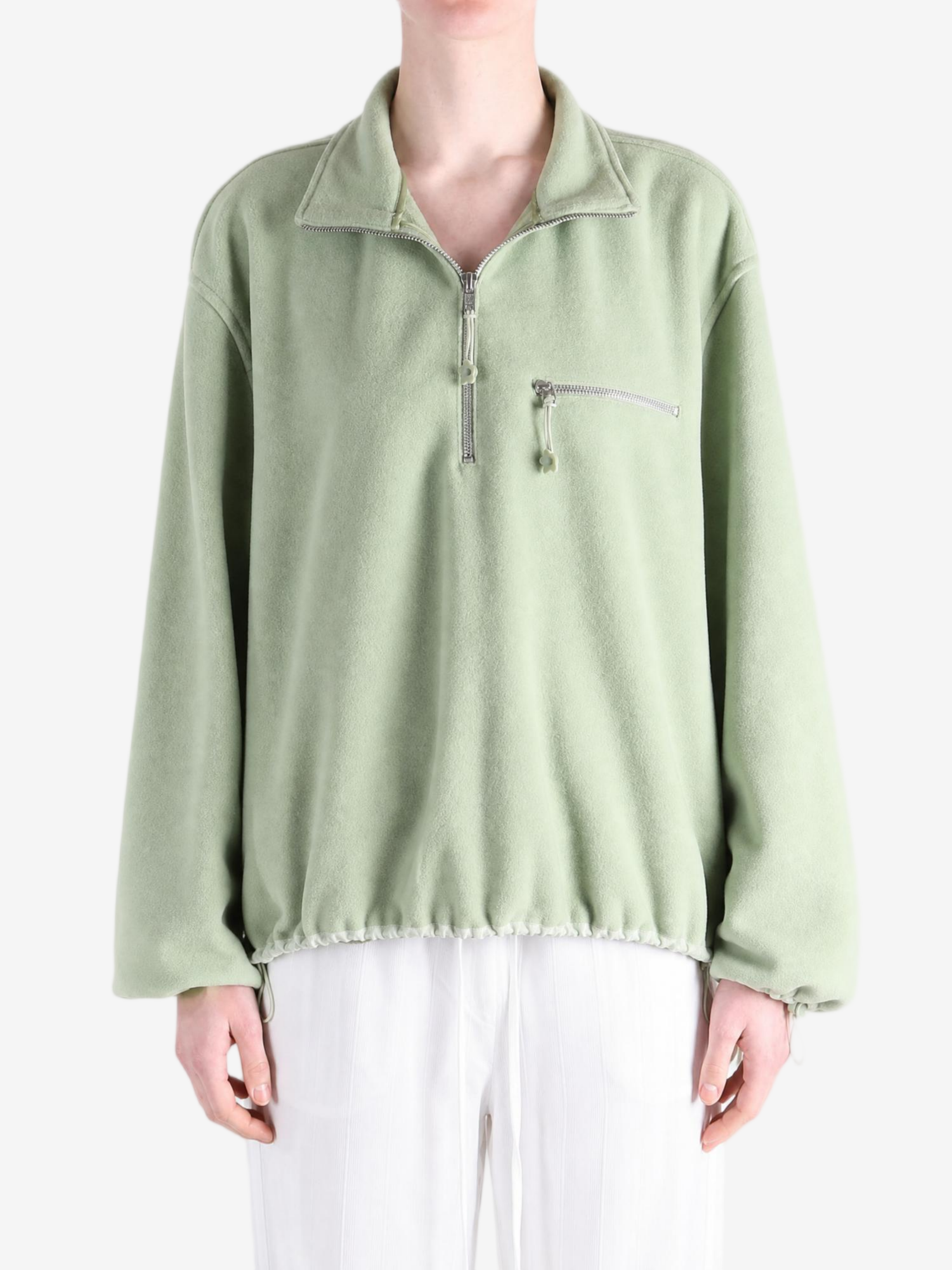 Green jacket worn by a person, showing the jacket fit