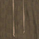 Close up of brown pants, showing texture of the linen fabric