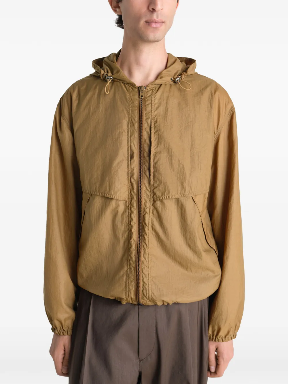 Tan jacket worn by a person, showing the jacket fit