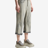 Grey pants worn by a person, showing the pants fit