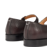 Close up of brown shoes, showing texture of the leather fabric