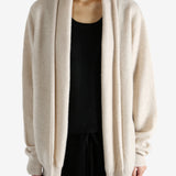 Tan cardigan worn by a person, showing the cardigan's fit