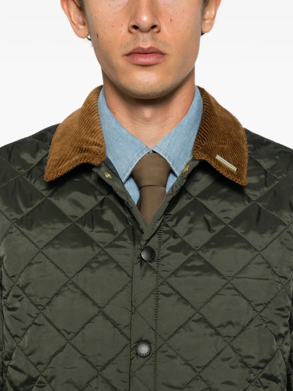 Green jacket worn by a person, showing the jacket fit