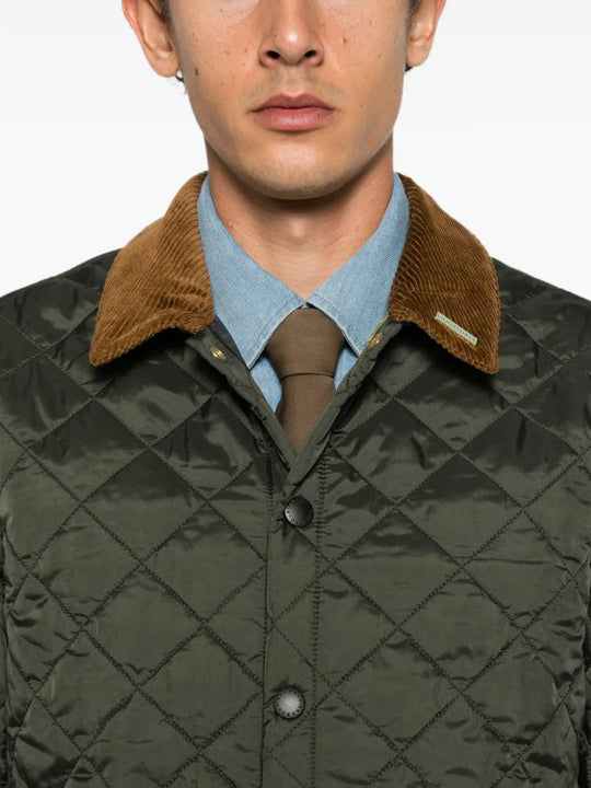 Green jacket worn by a person, showing the jacket fit