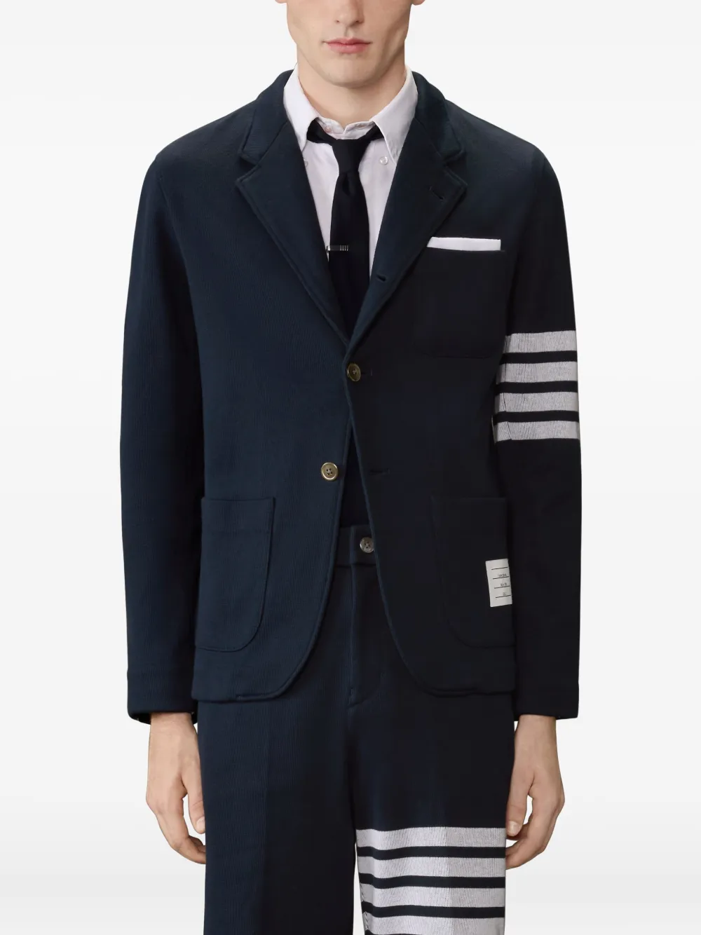 navy jacket worn by a person, showing the jacket fit