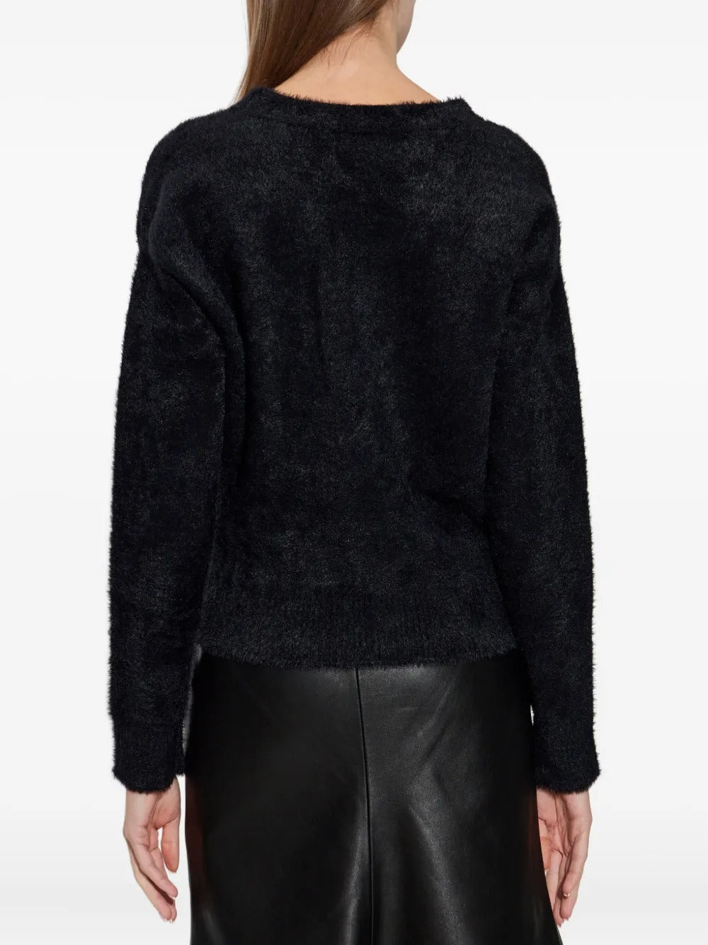 Black knitwear worn by a person, showing the knitwear fit