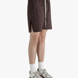 Brown shorts worn by a person, showing the shorts's fit