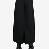 Black pants worn by a person, showing the pants's fit