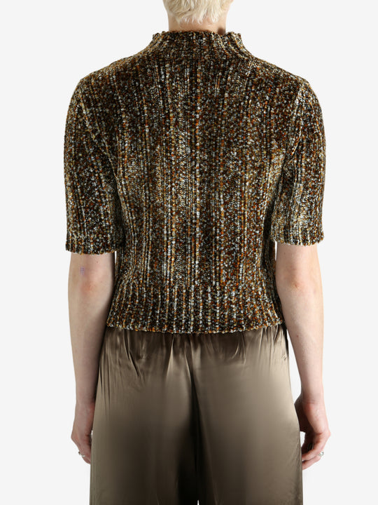 Grey knitwear worn by a person, showing the knitwear's fit