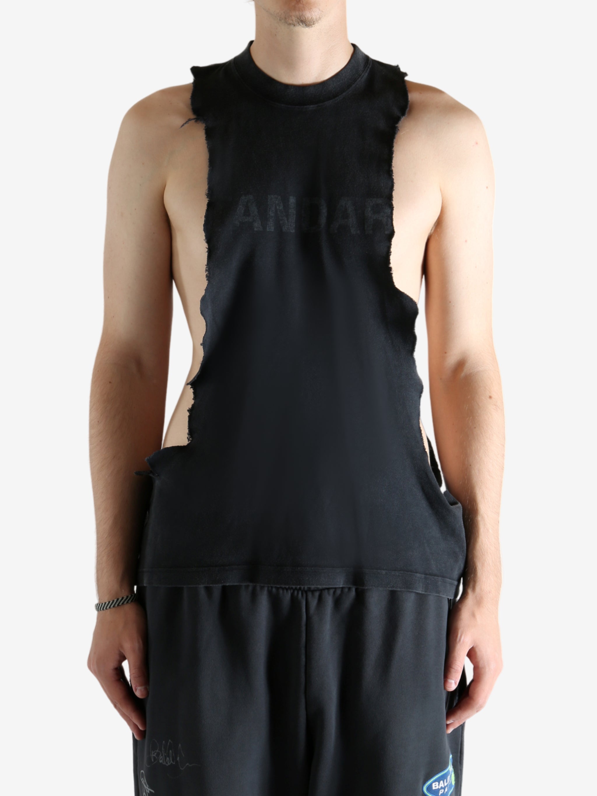 Black tops worn by a person, showing the tops's fit