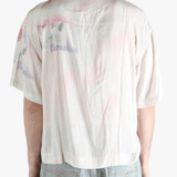 White shirt worn by a person, showing the shirt's fit