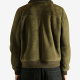 Green jacket worn by a person, showing the jacket's fit