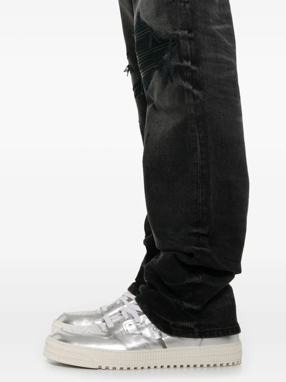 Close up of the black jeans, showing texture of the cotton fabric