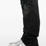 Close up of the black jeans, showing texture of the cotton fabric