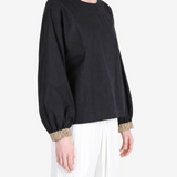 Black top worn by a person, showing the top fit