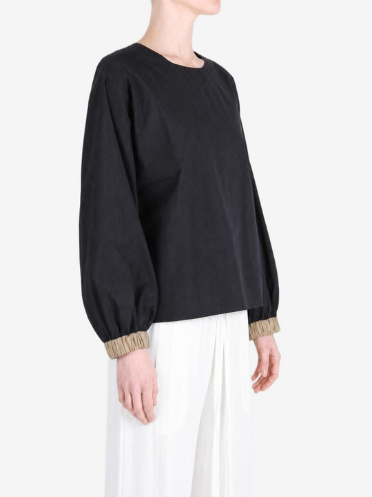 Black top worn by a person, showing the top fit