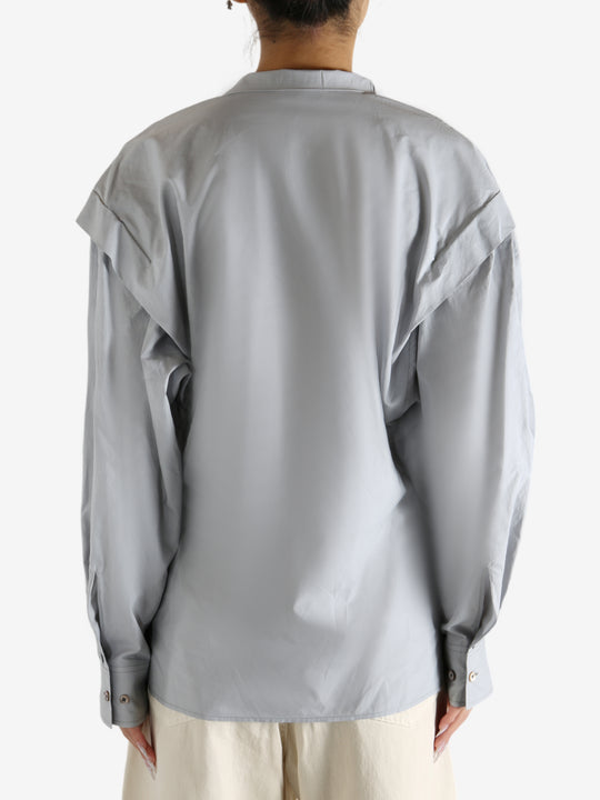 Grey blouse worn by a person, showing the blouse's fit