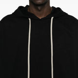Black hoodie worn by a person, showing the hoodie fit
