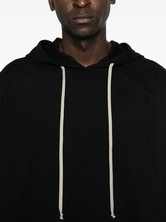 Black hoodie worn by a person, showing the hoodie fit
