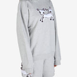 Grey knitwear worn by a person, showing the knitwear's fit