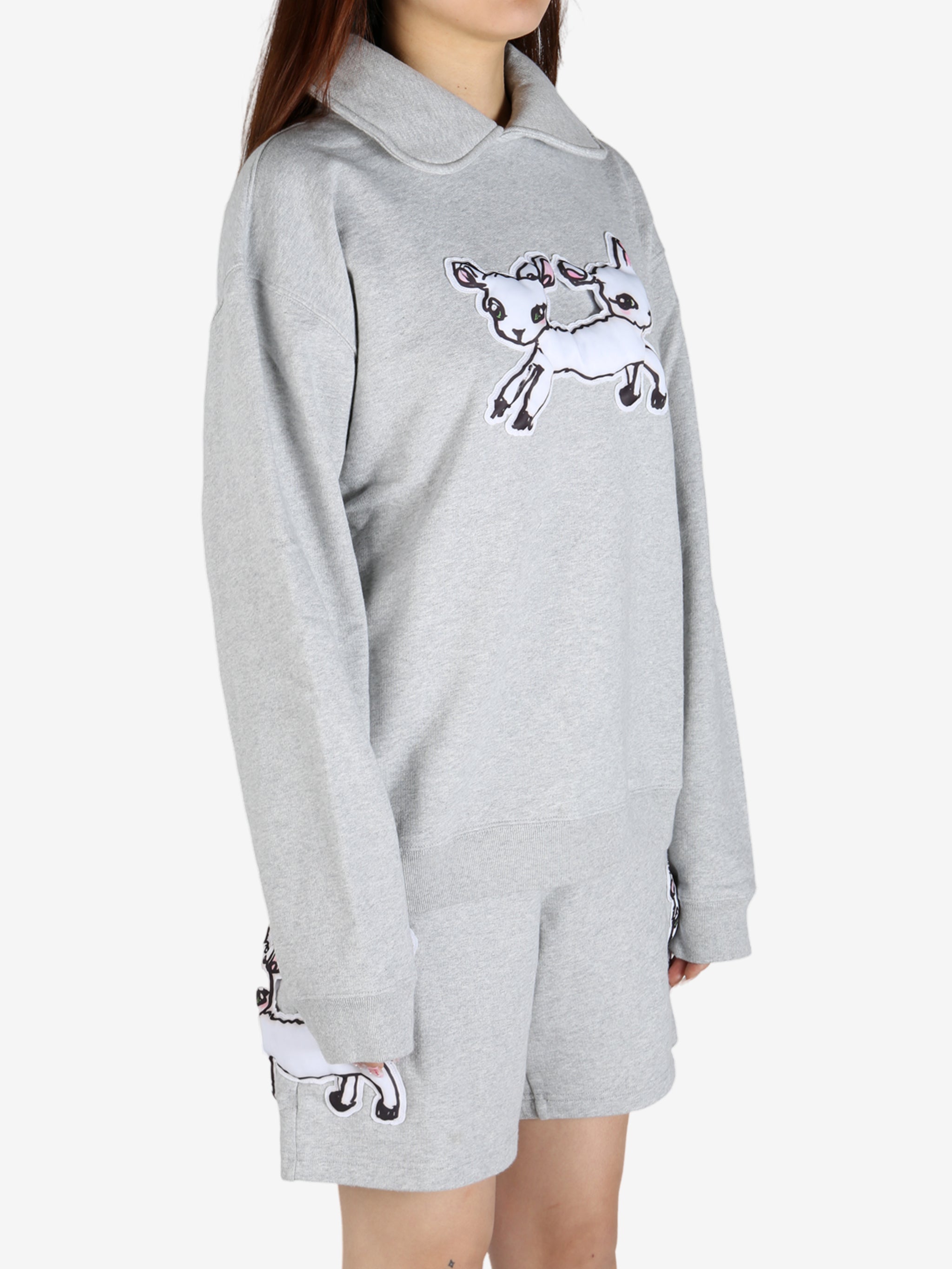 Grey knitwear worn by a person, showing the knitwear's fit