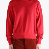 Red knitwear worn by a person, showing the knitwear's fit