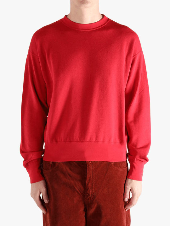 Red knitwear worn by a person, showing the knitwear's fit
