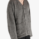 Grey cardigan worn by a person, showing the cardigan's fit