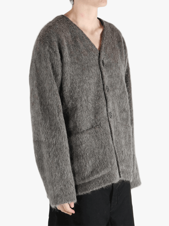 Grey cardigan worn by a person, showing the cardigan's fit