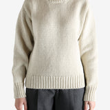 Tan sweater worn by a person, showing the sweater fit