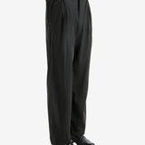 Black pants worn by a person, showing the pants' fit